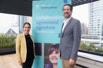 Woman and man standing on either side of a banner that reads "Centro de Competencias Tecmilenio collaboration agreement signature September 30 2022."