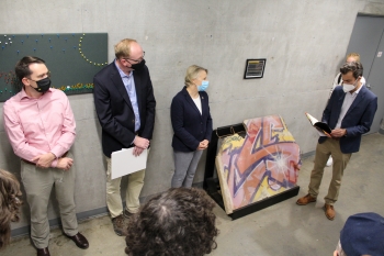 Image of Henry Thomson, Volker Benkert and Richard Amesbury speaking in front of a piece of the Berlin Wall at it's unveiling event in October.