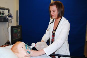 med student simulating giving oxygent to mannequin