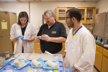 Photo of three people in a lab. Caption: ASU geotechnical engineering expert Ed Kavazanjian (middle) earned the American Society of Civil Engineers' highest honor for his outstanding career achievements.