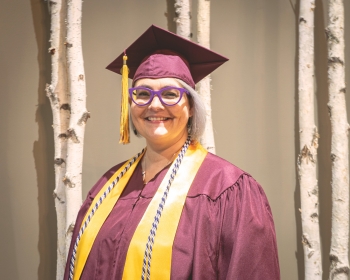 Kristine Anderson pictured wearing her ASU graduation gown and stole.
