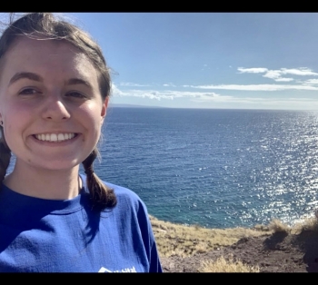 Smiling girl with ocean in background