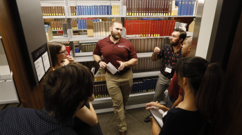 students having a discussion in a law library
