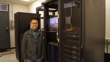 ASU graduate student Mingming Li standing in front of computer clusters