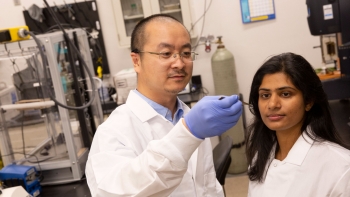 ASU Assistant Professor Kenan Song and research collaborator Mounika Kakarla wearing white coats in a lab.
