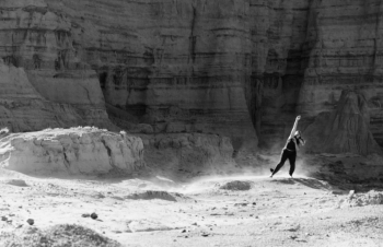 A dancer performs in a desert landscape