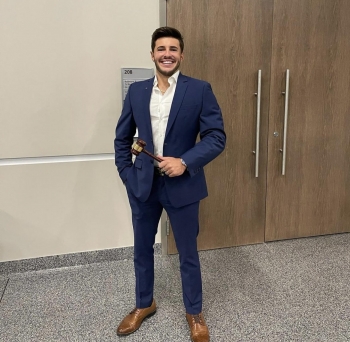 ASU student Nicolas Khonaysser wearing a suit and smiling.