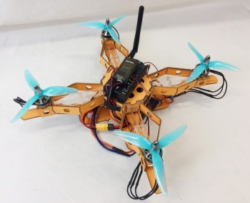 Image depicts a quadrotor prototype with controller on the top