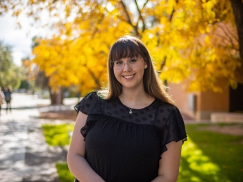 Kiana Guarino, a senior undergraduate psychology major at ASU, is pictured from midsection up smiling in an outdoor setting.
