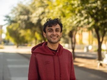 ASU grad student Belal Jamil smiling at the camera in an outdoor setting.