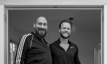 Black-and-white photo of Toby Prosky and Duncan Blount, creators of the Prosky Blount Scholarship for Interplanetary Prosperity, smiling at the camera.