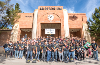 Participants in the Phoenix Indian Center Youth Leadership Day pose in front of an auditorium. / Photo by Phoenix Indian Center