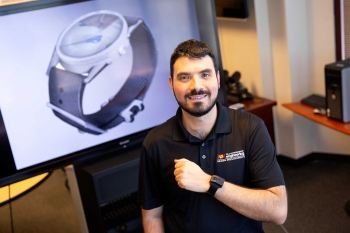 ASU Assistant Professor Troy McDaniel wearing a watch-like device on his wrist.