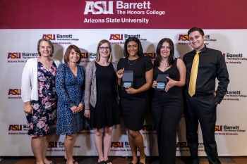Photo of Barrett Poly Gold Standard Award winners holding awards and standing in a line together smiling at the camera in front of an ASU Barrett backdrop.