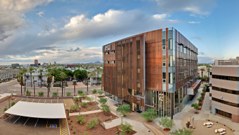 Exterior view of ASU's Edson College of Nursing and Health Innovation Health North Building against the Downtown Phoenix skyline.