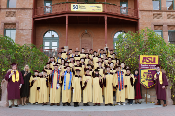 Group photo of ASU alumni from the classes of 1970 and 1971 on the steps of Old Main on the Tempe campus.