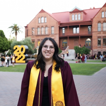 Portrait of ASU grad Stephanie Gerhart in front of the Old Main building on the Tempe campus.