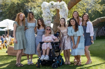 A group of female students pose for a photo outdoors at the Barrett Honors College Ladies' Tea.