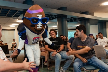 Super Bowl mascot Spike, a giant soccer ball, greets ASU students at a panel event.