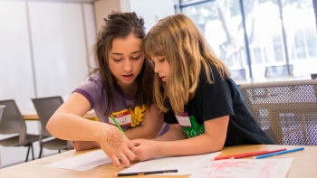 Elizabeth Jones assists an elementary school student at GEAR Day 2018.