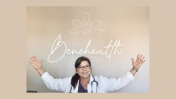 Tanya Carroccio wears a white nurse practitioner coat and stethoscope with her arms raised in the air underneath a sign that says Benehealth in cursive 