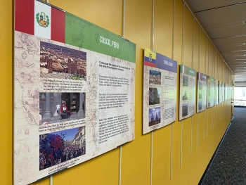 Exhibit panels with text about cities in the Tempe Sister Cities program hanging on a yellow wall.