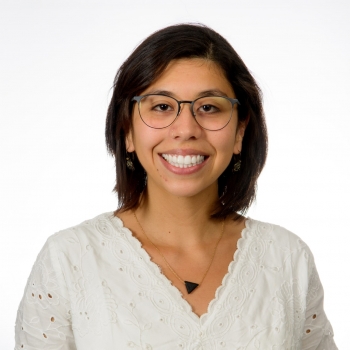 Portrait of ASU PhD graduate Ana María Meléndez Guevara, smiling in a white blouse.