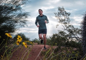 College of Health Solutions graduate Darrel Wang jogging on an outdoor trail.