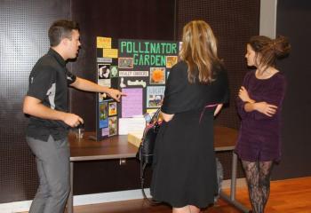 Students make a presentation about a pollinator garden.