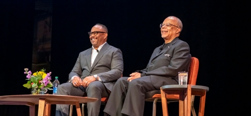 Henry Louis Gates Jr. and Cronkite School Dean Battinto L. Batts Jr. seated in chairs on a stage.