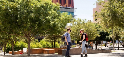 Students walk on a sidewalk on the downtown campus