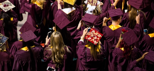 Overhead view of graduates in maroon caps and gowns