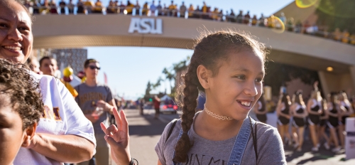 girl making pitchfork sign with hand at ASU Homecoming parade