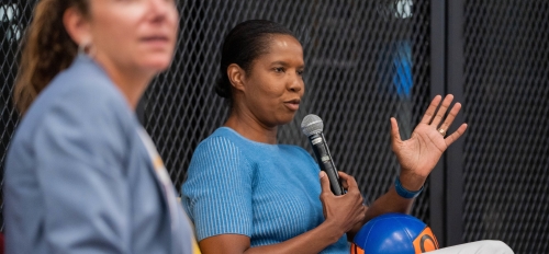 Woman holding microphone speaking at event