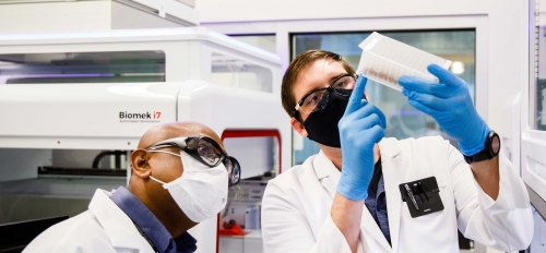 ASU clinical lab staff check a sample block before RNA isolation