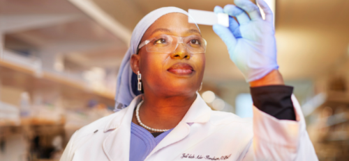woman looking at slide in lab