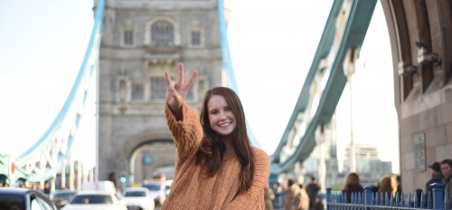 ASU student smiling holding up a pitchfork on the London Bridge