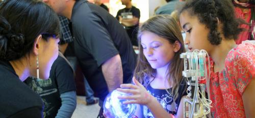 Young scholars examine research artifact at the Biodesign Institute at ASU at Night of the Open Door