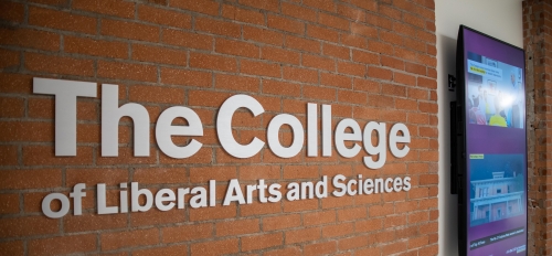 Sign on a brick wall that reads "The College of Liberal Arts and Sciences."
