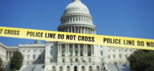 U.S. Capitol building with police caution tape in front of it.