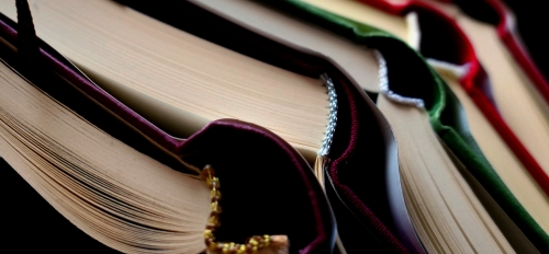Pixabay image of open books stacked up on each other