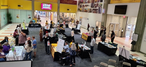 Visitors at booths at Celebrating Black Brilliance event, Watts College, IDEA Office, April 2022