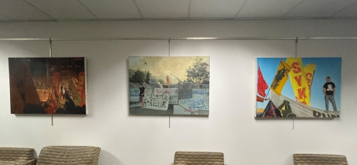 Paintings by artist Chris Vena on display in a hallway at ASU's University Center as part of the Watts College for Public Service and Community Solutions program "Action, Advocacy and Art."