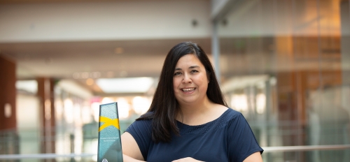 Portrait of ASU Associate Professor Jennifer Blain Christen, posing with an award.