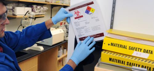A man posts a lab-safety warning in an ASU lab. 
