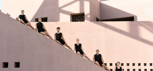 Six dancers pose on the diagonal steps of the ASU Art Museum, the lines of their leg matching the line of the architecture