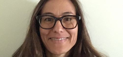 portrait of Camilla Fojas, director of ASU’s School of Social Transformation. Fojas has long dark hair, is smiling and wearing glasses