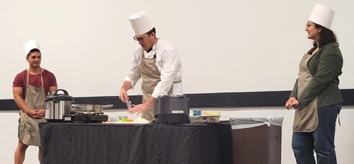 Chef Kenneth Moody demonstrates chopping ingredients for use in a pressure cooker.