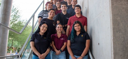Students of the ASU chapter of the Society of Hispanic Professional Engineers pose for a group photo on a staircase.