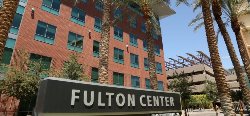 Exterior shot of ASU building with a sign that reads "Fulton Center" and palm trees.